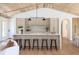Bright kitchen featuring an island with barstools, stone countertops, and light wood vaulted ceilings at 1183 Farm Quarter Rd, Mount Pleasant, SC 29464