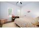 Bright bedroom with a floral patterned quilt and a wooden storage shelf at 1183 Guerins Bridge Rd, Awendaw, SC 29429