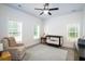 Bright Bedroom with a dark crib, ceiling fan, and accent chair on top of an area rug at 1183 Guerins Bridge Rd, Awendaw, SC 29429
