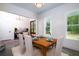 Open dining space with wood table, white chairs, and views into the foyer at 1183 Guerins Bridge Rd, Awendaw, SC 29429