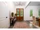 Inviting entryway featuring wood double doors, a console table with decor, and a stylish chandelier at 1183 Guerins Bridge Rd, Awendaw, SC 29429