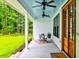 Inviting front porch with blue ceiling, white pillars, and outdoor furniture, creating a relaxing entryway at 1183 Guerins Bridge Rd, Awendaw, SC 29429