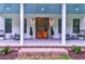 Charming front porch with double doors, potted plants, and cozy seating, offering a pleasant outdoor living space at 1183 Guerins Bridge Rd, Awendaw, SC 29429