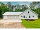 Spacious three-car garage with a concrete driveway and manicured landscaping at 1183 Guerins Bridge Rd, Awendaw, SC 29429