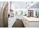 Modern kitchen with stainless steel appliances, white cabinets, and a large island with quartz countertops at 1183 Guerins Bridge Rd, Awendaw, SC 29429
