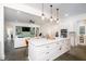 Open concept kitchen with white cabinets, a large island with quartz countertops, and stainless steel appliances at 1183 Guerins Bridge Rd, Awendaw, SC 29429