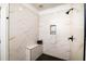 Newly remodeled shower with marble-look tile and black herringbone flooring at 1183 Guerins Bridge Rd, Awendaw, SC 29429