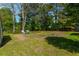 Spacious backyard features a well-maintained lawn, mature trees, and seating, perfect for outdoor enjoyment at 119 Alwyn Blvd, Summerville, SC 29485