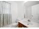 Bright bathroom features wood vanity with sink, mirror, toilet, and window with patterned curtain at 119 Alwyn Blvd, Summerville, SC 29485