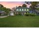 Charming two-story home with green shutters, a manicured lawn, and attached two car garage at 119 Alwyn Blvd, Summerville, SC 29485