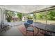 Relaxing screened porch with seating and table provides a great space to enjoy the outdoors at 119 Alwyn Blvd, Summerville, SC 29485
