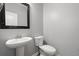 Cozy powder room with pedestal sink, framed mirror and toilet at 121 Dream St, Summerville, SC 29483