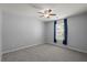 Cozy bedroom with neutral walls, ceiling fan and a bright window at 121 Dream St, Summerville, SC 29483
