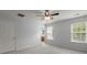 Well-lit bedroom with two windows, ceiling fan, and neutral carpet, leading to an ensuite bathroom at 121 Dream St, Summerville, SC 29483