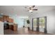Open-concept living room with wood floors, a ceiling fan, light blue accent wall, and a dining area at 121 Dream St, Summerville, SC 29483