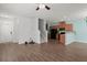 Living room with wood floors, a ceiling fan, light blue accent wall, and a staircase at 121 Dream St, Summerville, SC 29483