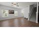 Living room with wood floors, a staircase, a mirror, and three windows with window blinds at 121 Dream St, Summerville, SC 29483