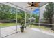 Relaxing screened porch with ceiling fan overlooking a backyard with mature trees and wooden fence at 121 Dream St, Summerville, SC 29483