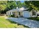 Charming single-story home with a well-maintained yard and a private driveway leading to an attached garage at 124 Droos Way, Charleston, SC 29414