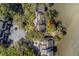 Aerial view of home surrounded by lush trees and next to parking at 1242 Creek Watch, Seabrook Island, SC 29455