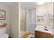 Cozy bathroom featuring a glass-enclosed shower, single vanity and wood look floors at 1242 Creek Watch, Seabrook Island, SC 29455
