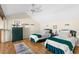 Charming bedroom featuring twin beds, wood floors, and ample storage at 1242 Creek Watch, Seabrook Island, SC 29455