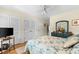 Comfortable bedroom with light-colored walls, wood floors, and a dresser with decor at 1242 Creek Watch, Seabrook Island, SC 29455