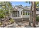Charming single-Gathering home boasts a deck, mature trees and a light-filled sunroom at 1242 Creek Watch, Seabrook Island, SC 29455