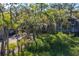 A view of the townhome exterior, shaded by mature trees and lush vegetation at 1242 Creek Watch, Seabrook Island, SC 29455