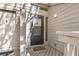 Neutral-colored home with a gray front door and adjacent side door and transom window at 1242 Creek Watch, Seabrook Island, SC 29455