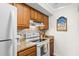 Cozy kitchen featuring wood cabinetry, white appliances, and granite countertops at 1242 Creek Watch, Seabrook Island, SC 29455