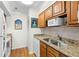 Functional kitchen featuring wood cabinets, stone countertops and stainless steel sink at 1242 Creek Watch, Seabrook Island, SC 29455