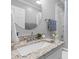 Bathroom with a granite countertop, round mirror, and stylish fixtures at 1324 Maxwell St, North Charleston, SC 29405