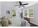 Bright bedroom with a ceiling fan, neutral walls, and windows that stream in natural light at 1324 Maxwell St, North Charleston, SC 29405