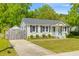 Charming home with an inviting front porch and a well-kept lawn at 1324 Maxwell St, North Charleston, SC 29405