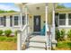 Inviting front porch with decorative door, well-manicured bushes, and a bright teal chair at 1324 Maxwell St, North Charleston, SC 29405