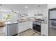 Bright open floorplan kitchen boasts stainless appliances, granite counters, and an adjacent living space at 1324 Maxwell St, North Charleston, SC 29405