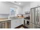 Well-lit kitchen with stainless appliances, granite countertops, and white cabinetry at 1324 Maxwell St, North Charleston, SC 29405