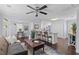 Open-concept living space with hardwood floors, modern furnishings, and a kitchen island at 1324 Maxwell St, North Charleston, SC 29405