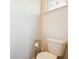 Cozy half bath with toilet, toilet paper holder, and window at 136 Pontoria Dr, Summerville, SC 29483