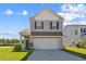 Charming two-story home featuring a two-car garage and well-manicured front lawn at 136 Pontoria Dr, Summerville, SC 29483