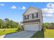 Two-story home with a two-car garage, set on a verdant lot with mature trees at 136 Pontoria Dr, Summerville, SC 29483