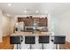 Well-equipped kitchen features an island with granite counters and bar stool seating at 136 Pontoria Dr, Summerville, SC 29483