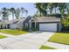 Charming home with a well-maintained lawn, modern gray siding, and an attached garage at 1411 Thin Pine Dr, Johns Island, SC 29455
