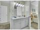 Updated bathroom featuring a white vanity with marble top, decorative lighting, and a view into the main bedroom at 1481 Battery Reynolds Ct, Charleston, SC 29412
