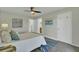 This primary bedroom features stylish furnishings and artwork with doorways to the ensuite bathroom and closets at 1481 Battery Reynolds Ct, Charleston, SC 29412