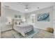 Bright bedroom featuring a queen-size bed, coastal artwork, and a ceiling fan at 1481 Battery Reynolds Ct, Charleston, SC 29412