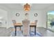 Bright dining area with modern light fixture, stylish decor, and sliding doors for outdoor access at 1481 Battery Reynolds Ct, Charleston, SC 29412