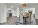 Open dining area with modern lighting that leads to a white kitchen with stainless steel appliances at 1481 Battery Reynolds Ct, Charleston, SC 29412