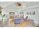 Airy living room with vaulted ceiling, jute rug, and an open floor plan with staircase to the second story at 1481 Battery Reynolds Ct, Charleston, SC 29412